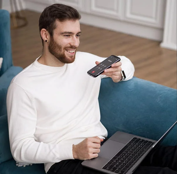 Man using smartphone and laptop for online support