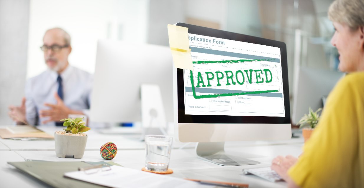 A woman is sitting in front of the desktop to check the approved peptide merchant account for the peptide business.